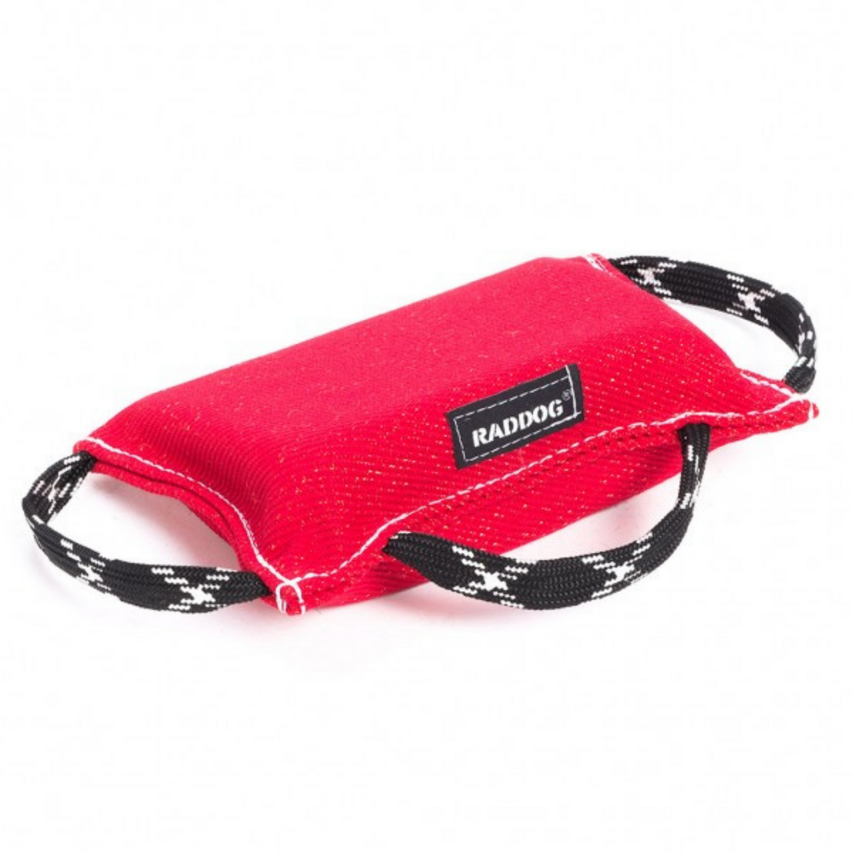 Red dog training bite wedge made of durable textured fabric with reinforced white stitching and two black-and-white patterned handles, featuring a “RADDOG” label, isolated on a white background.