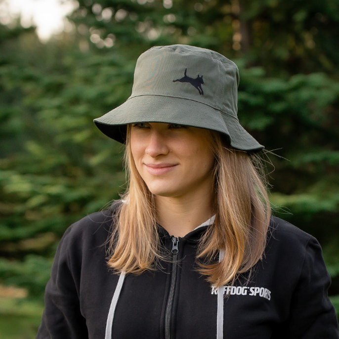 Woman wearing an olive green bucket hat for shade from the sun