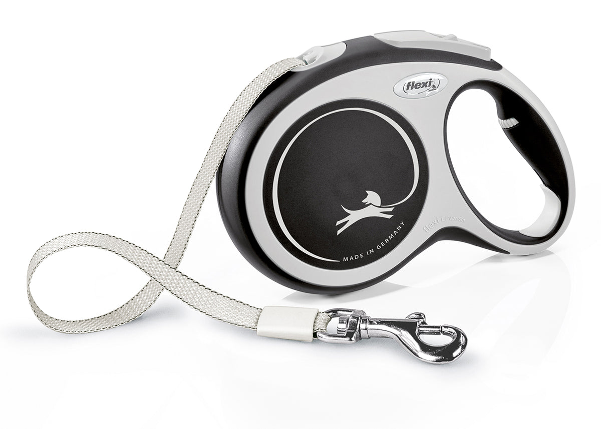 A retractable dog leash with a black and silver color scheme, featuring a soft grip, a chromed snap hook, and a short-stroke braking system.